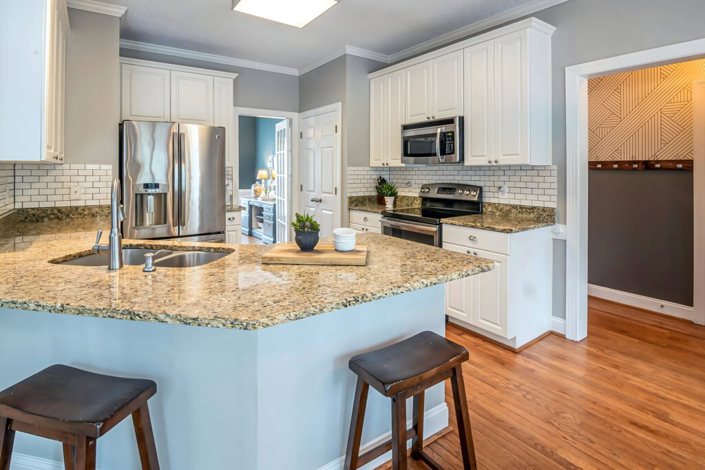 Modern kitchen cabinet design with tall units and glass panels